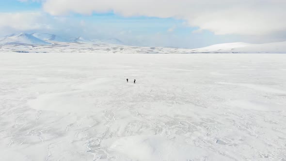 People Enjoy Walking On Frozen Lake In Paravani