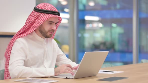 Arab Businessman Reacting to Failure on Laptop in Office Loss