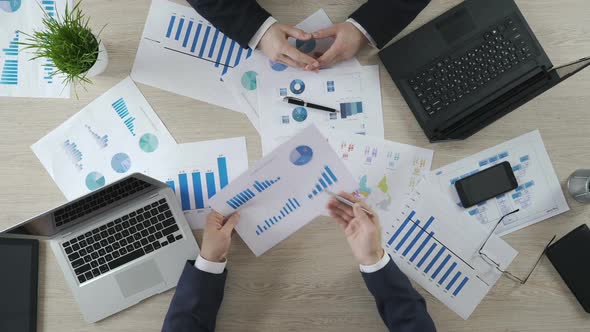 Two Men Checking Business Diagrams, Discussing Financial Report, Brainstorming