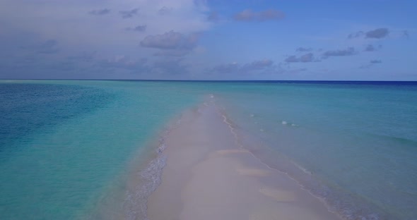 Daytime overhead tourism shot of a summer white paradise sand beach and aqua turquoise water backgro