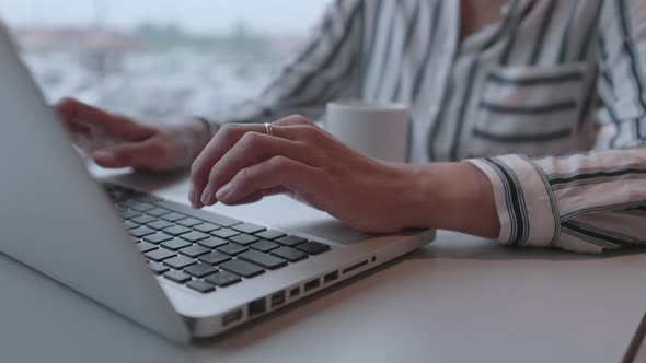 Business Woman Works with Laptop in Coworking Center