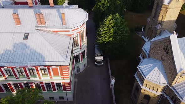 Aerial view of garbage truck after loading waste automatically, shifting dumpster, early summer morn