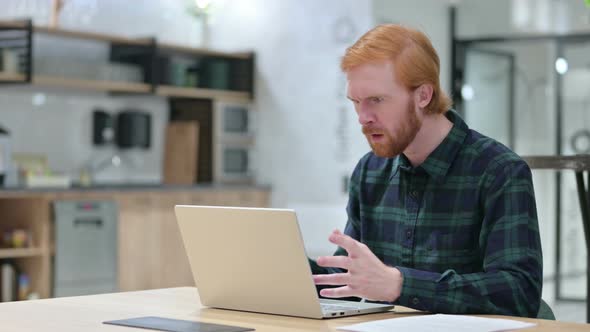 Beard Redhead Man Reacting To Loss on Laptop in Cafe 