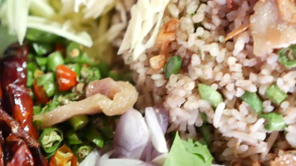 Close Up Footage of Thai Style Shrimp Paste Fried Rice (Khao Klook Krapi) Served With Fried Egg, Swe