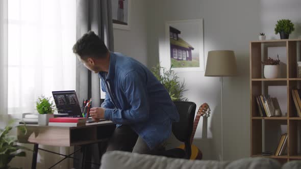 Young Handsome Man Getting Down to Work at Home Office