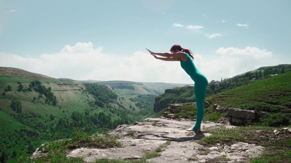 Athletic Girl Practices Yoga on Edge Mountain