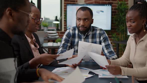 Company Employees Using Business Charts on Files to Plan Project