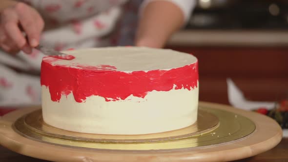 Close Up Shot of the Cake That Stands on the Tray the Cook Decorates the Dessert