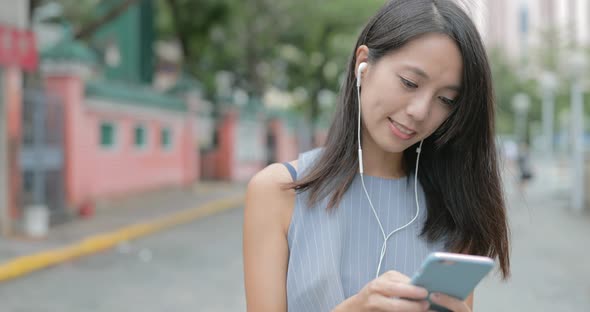 Woman Making a Video Call with Her Cellphone in The City 