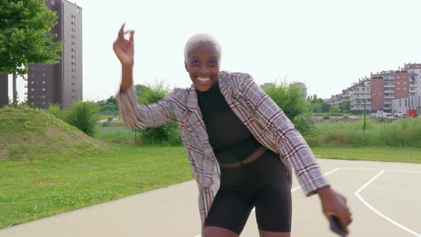 Young fashionable woman dancing in the city