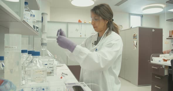 Scientist working in a pharmaceutical laboratory conducting experiments