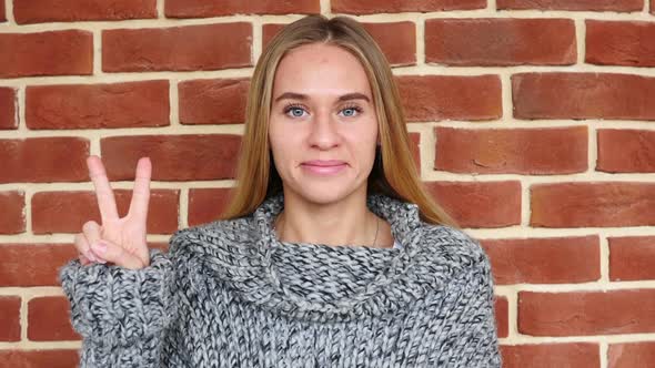 Victory Sign By Woman in Loft Office
