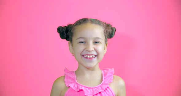 Funny Portrait on Pink Background of Happy Little Smiling Baby Girl Looking at Camera Cute Baby