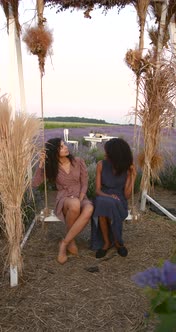 Female Diverse Friends on a Swing in Lavender Field