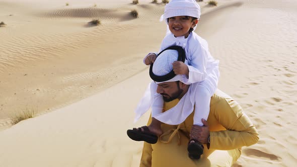 Father and son making a safari in the desert