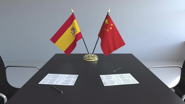 Flags of Spain and China on the Table alt