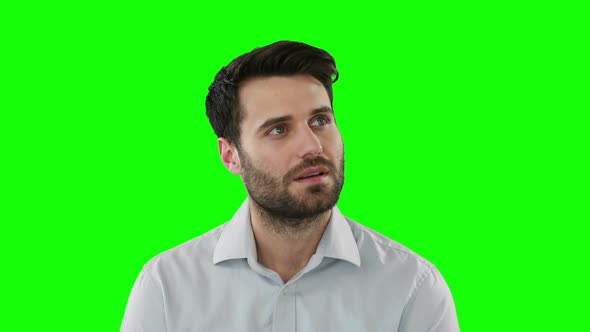 Young man standing against green screen