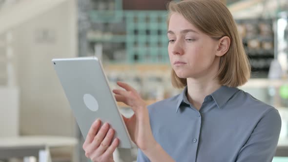 Portrait of Young Woman Using Digital Tablet