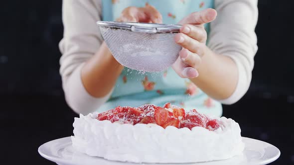 Woman icing sugar powder on tart 4k