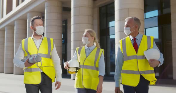 Team of Engineers in Protective Mask Walking Outside Office Building