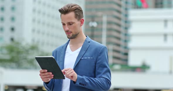 Businessman work on tablet computer at outdoor