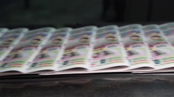 Printed Paper Newspapers Move Along Conveyor One After Another