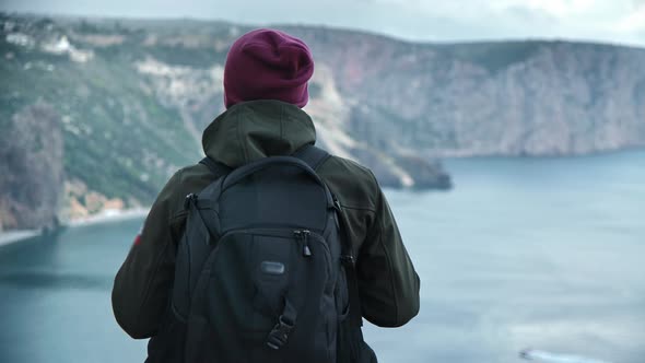 Back View Male Backpacker Enjoying Success Contemplating Sea Scenery From Mountain Top