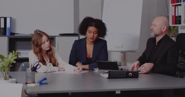 Businessman Discussing with Colleagues in Office