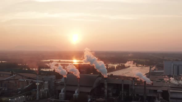 Aerial view Drone shot of flying around toxic chimneys tubing. Air Pollutants, Industrial zone.