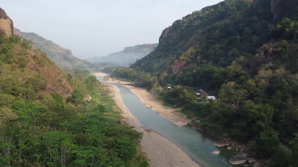 Beautiful aerial view of a river in the middle of the mountains in the morning