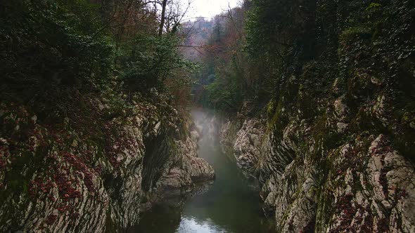 Flying Over a River Through a Narrow Canyon with White Rocks Sochi