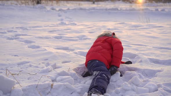 Little Boy Plays Snowballs with His Mother. Slowmotion Shot
