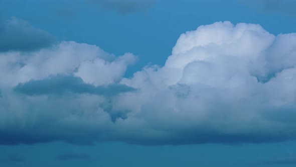 Picturesque Cumulus Clouds Float Fast Across Clear Blue Sky