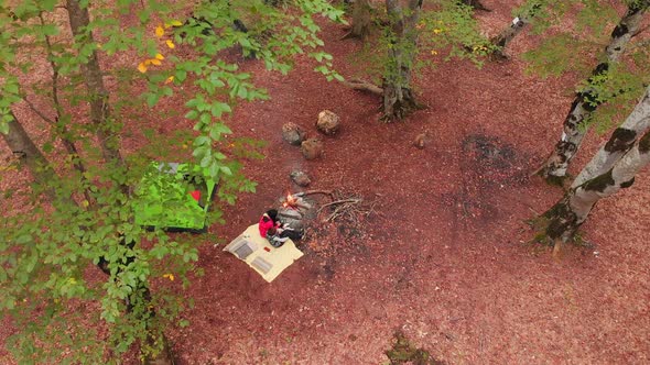 Rising Aerial View Of Single Mother With Child Camping Outdoors In Autumn