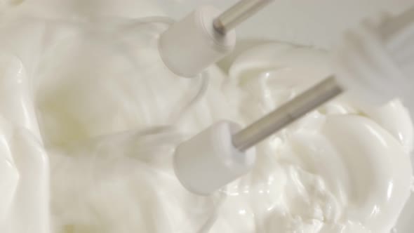 Hand mixing egg whites with mixer close-up 4K 2160p UHD footage - Mixing egg whites with electric mi