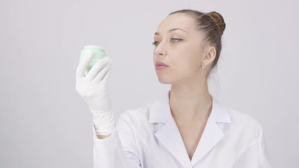 Pretty Dermatologist Analyzes Scientificallybacked Cream White Lab Background