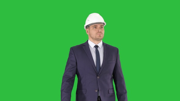 Construction worker in a suit putting on helmet Safety