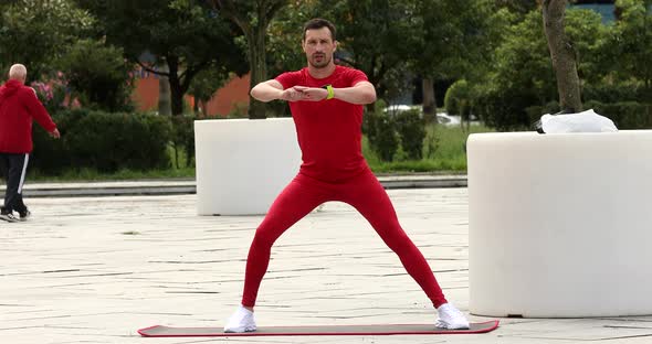 Man warm up and stretching outdoors for a workout.