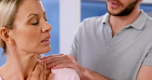 Female patient receiving neck massage from physiotherapist