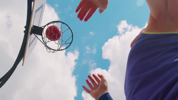 Upward View of Focused Senior Player Man Playing Basketball Game Successfully Hits Into Basket Ring
