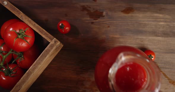 Man's Hand Puts on the Table a Jug of Tomato Juice. 