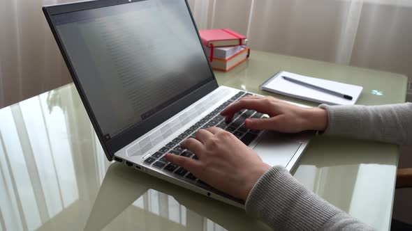 The girl working at home office hands on keyboard