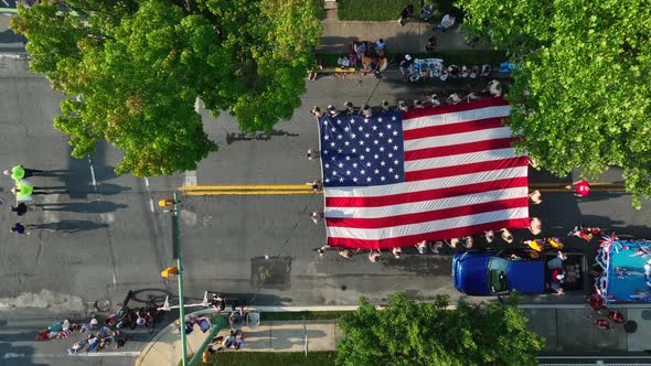 USA flag carried in parade by By Scouts. July 4 Independence Day holiday celebration in small town A