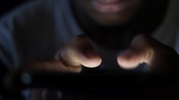 Close Up of Young Man Hand Using Smart Phone at Night 