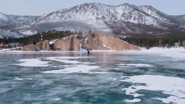 Aerial View of Man Skating on Lake Baikal Covered By Ice