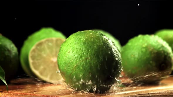 Lime Falls on a Cutting Board with Splashes of Water