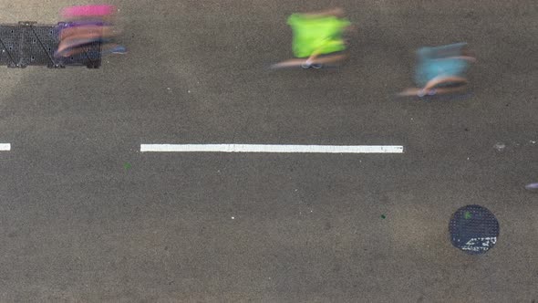 Aerial time lapse view of marathon runners running on tarmacked street