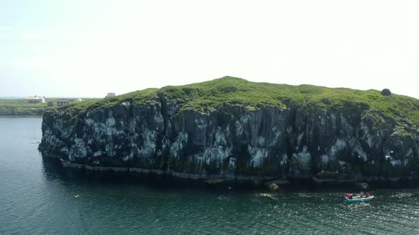 Rugged Mountains With Rowing Boat Near Flatey Island In Breidafjordur, Iceland. Aerial Pullback