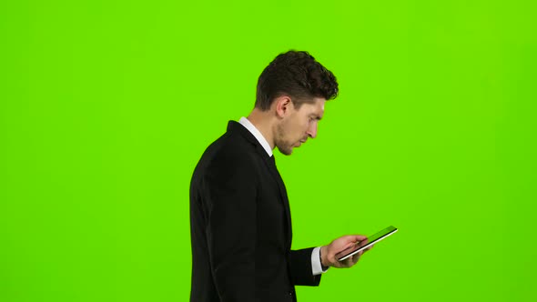 Businessman Is Going To Work and Prints Important Messages. Green Screen Side View