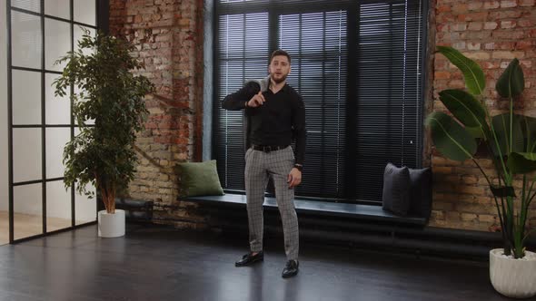 Handsome Young European Man Trying on a Business Gray Suit in a Clothing Store